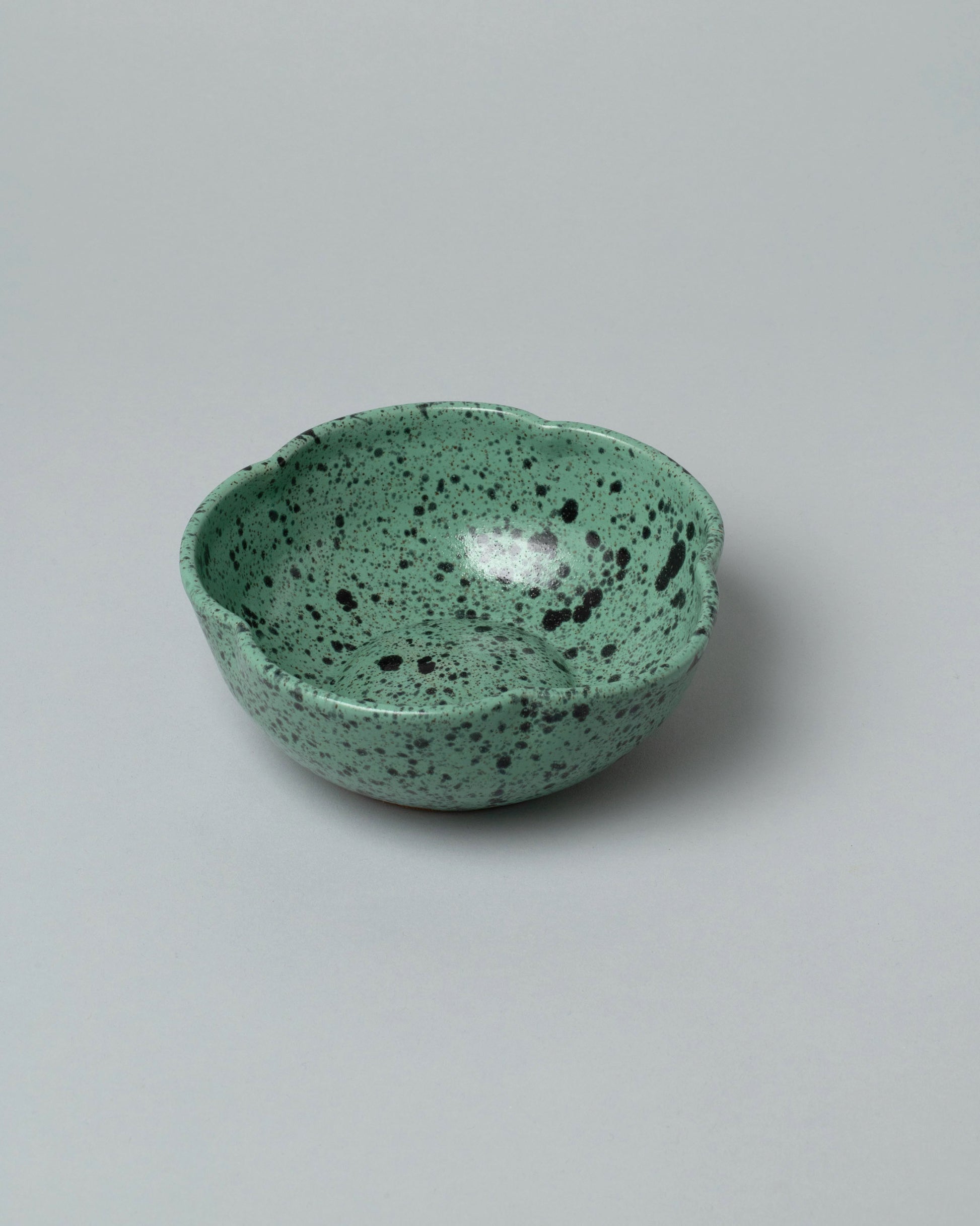Recreation Center Green Speckle Flower Bowl on light color background.