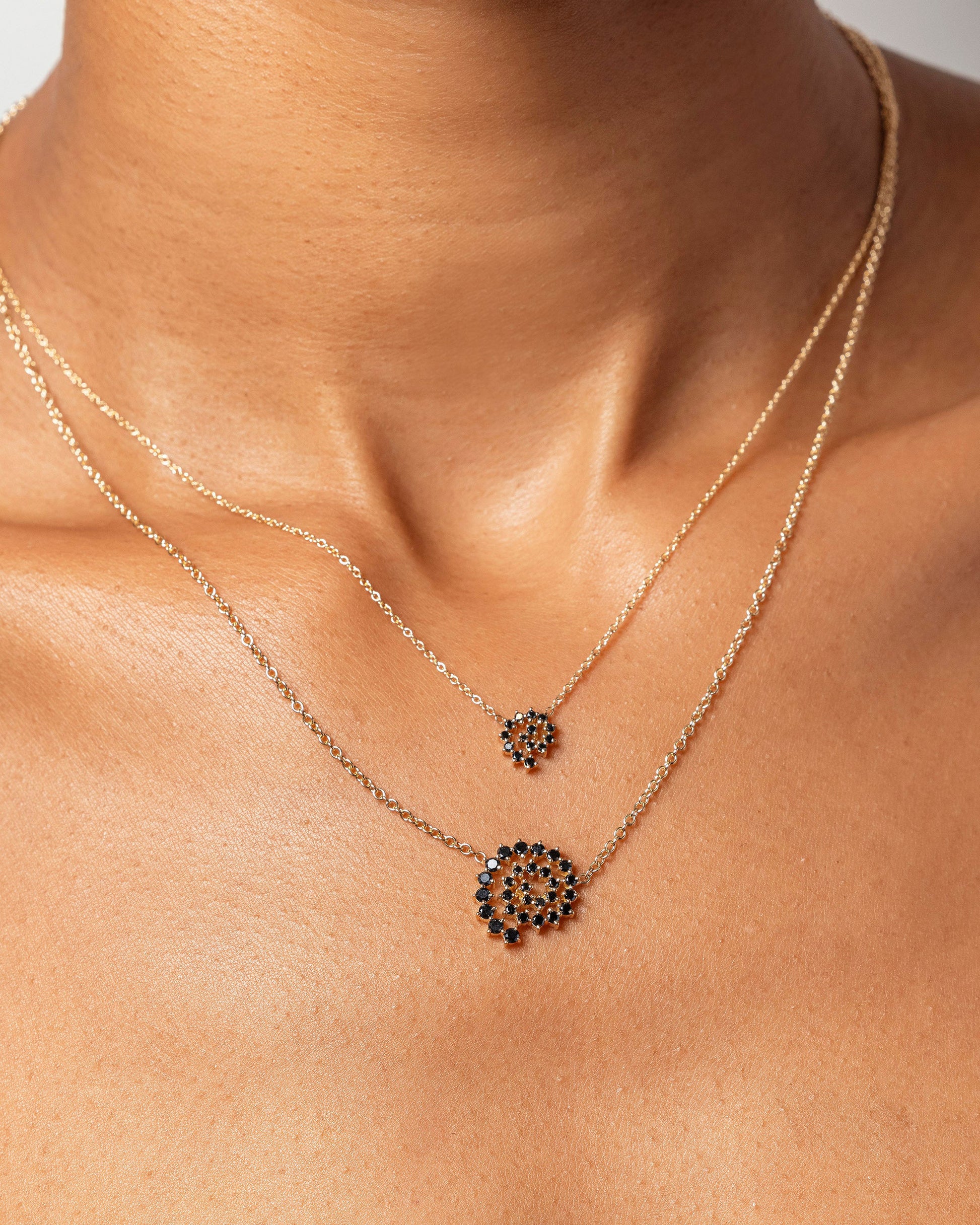 Mini and Full Black Diamond Spiral Necklaces on model.