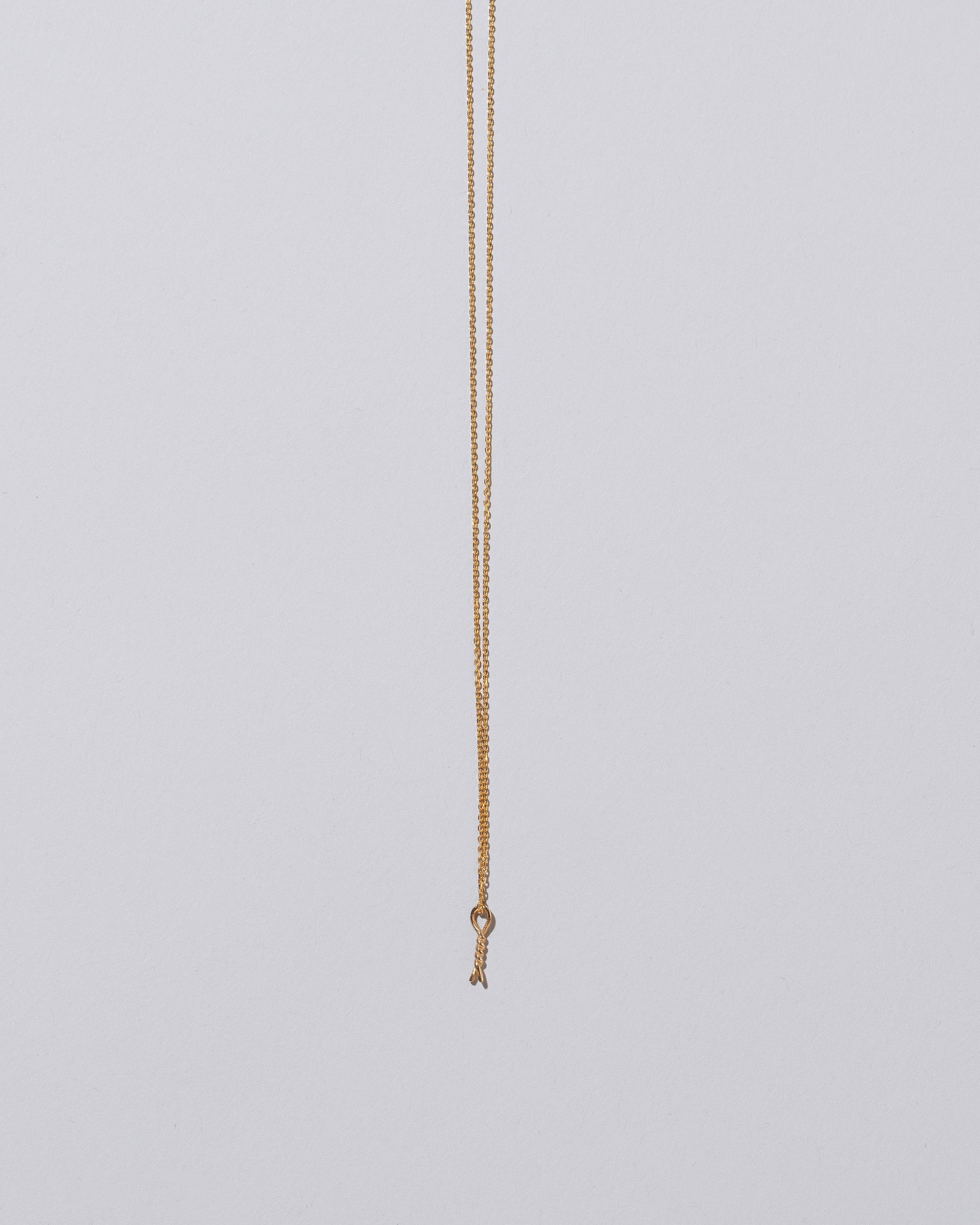 Twist Talisman Pendant Necklace on light color background.