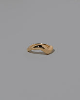 View from the side of the Gold Unbroken Band on light color background.