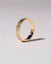 Gold Infinity Etched Band on light color background.