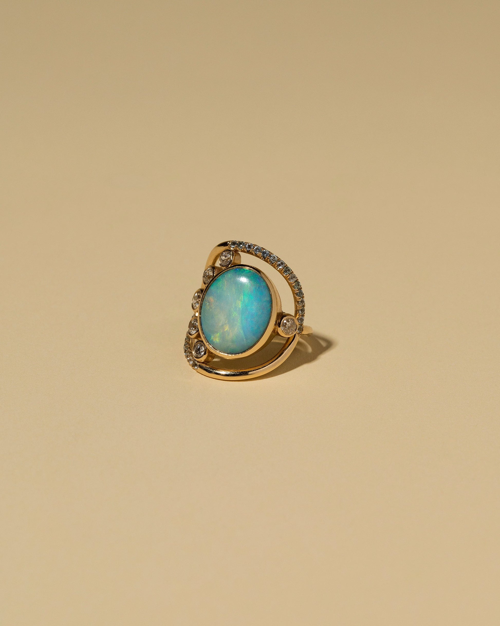 Australian Opal, Diamond & Sapphire Ring on light color background.