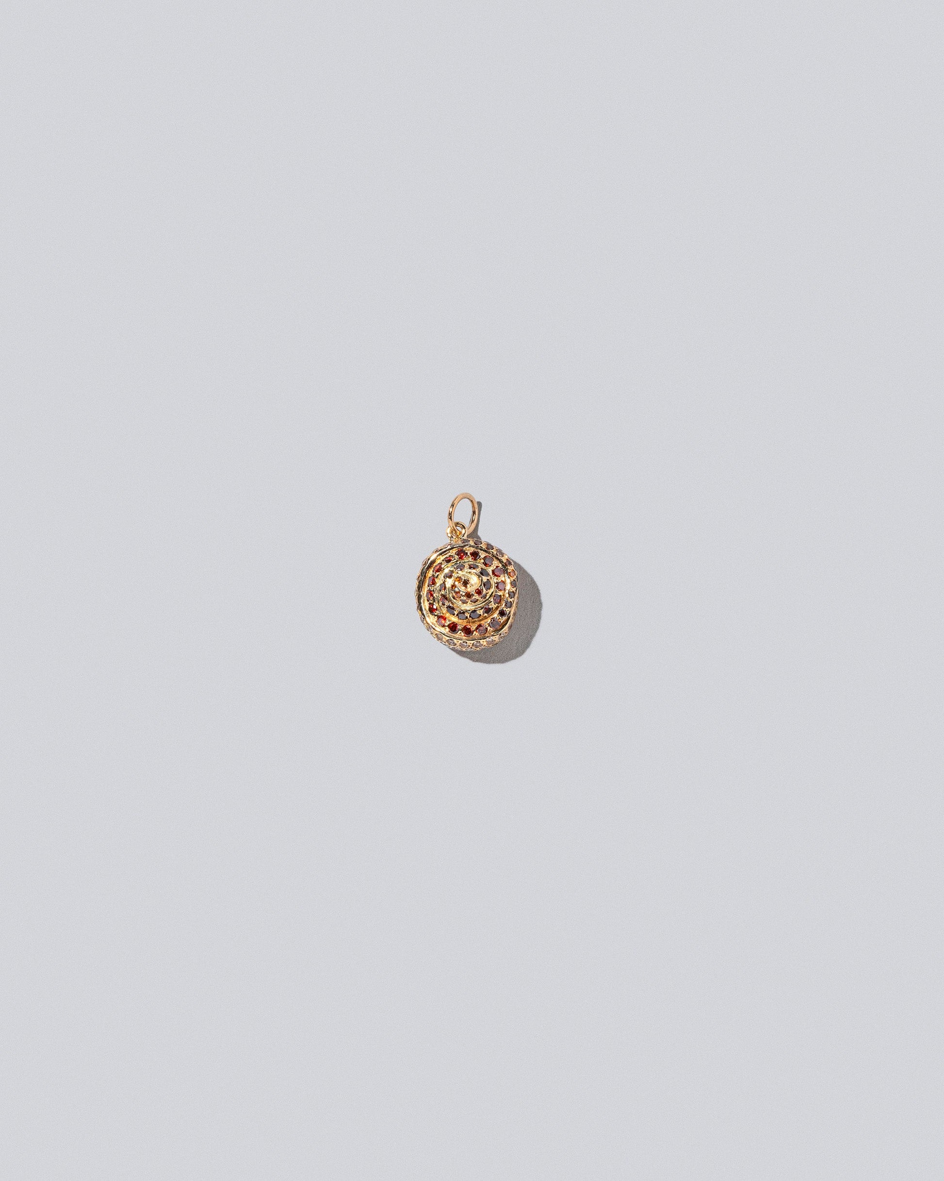 Cinnamon Roll Charm - Pavés on light color background.