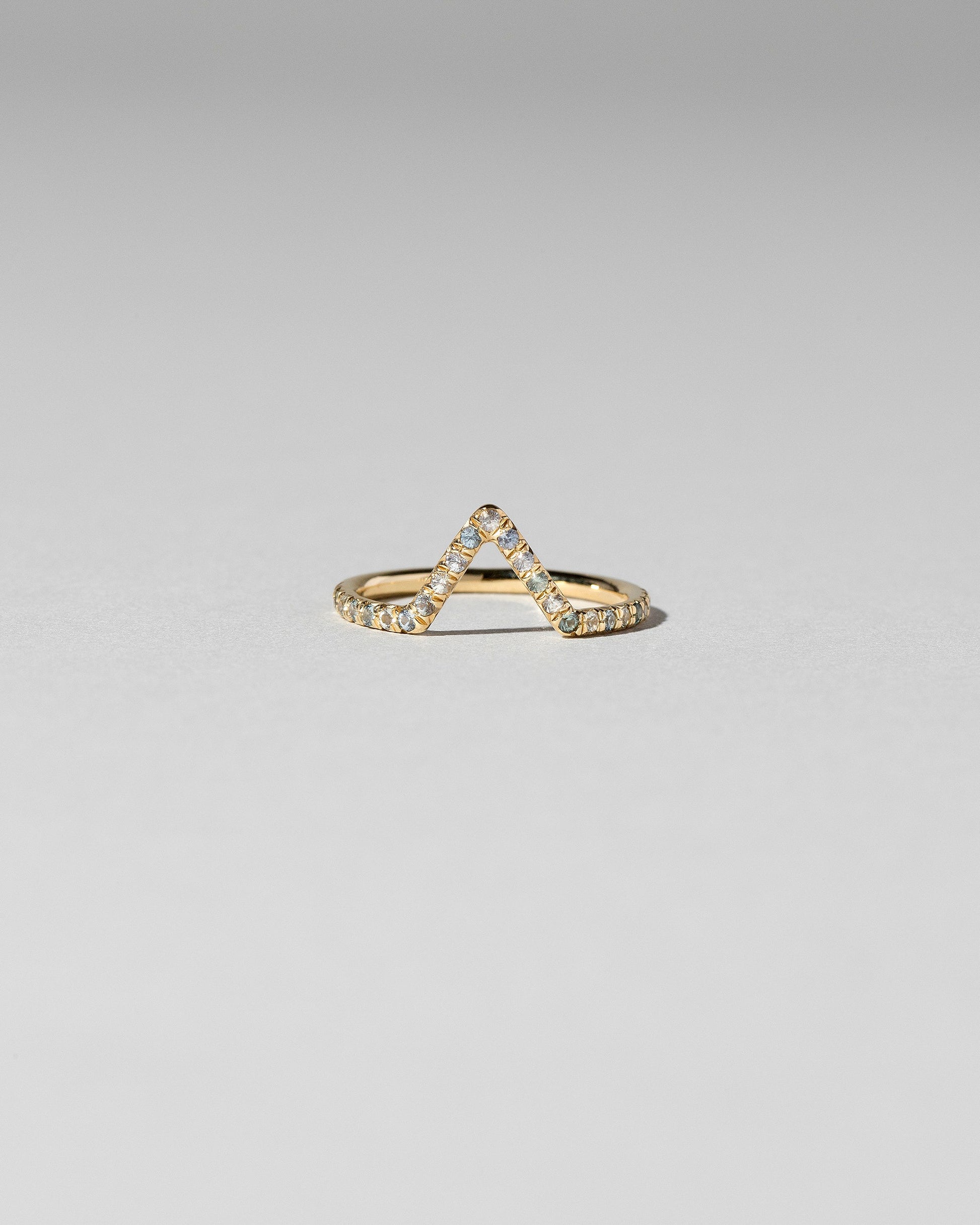 Blue Sapphire Pavé Triangle Band on light color background.