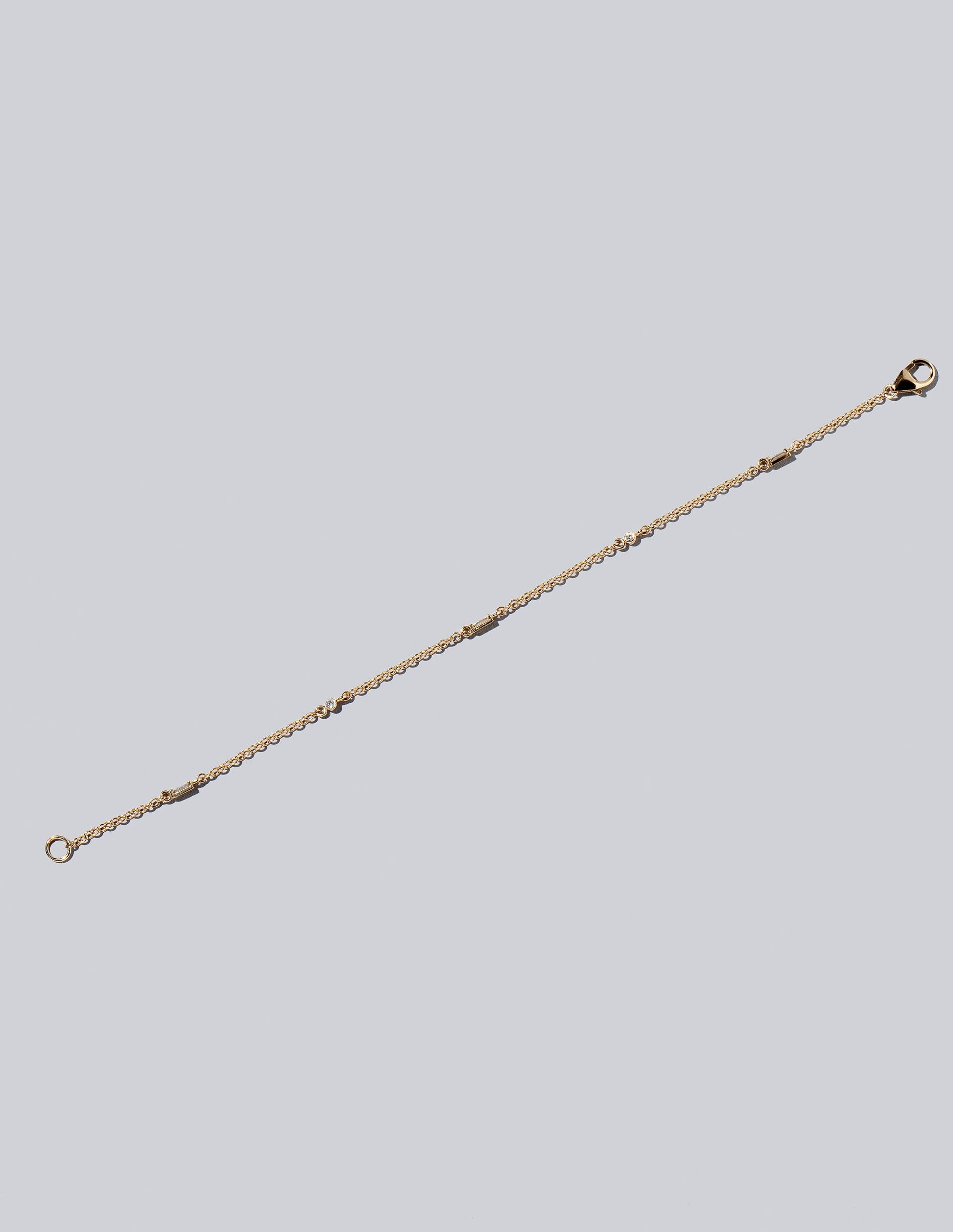 White Diamond Distributed Building Blocks Bracelet on light color background.