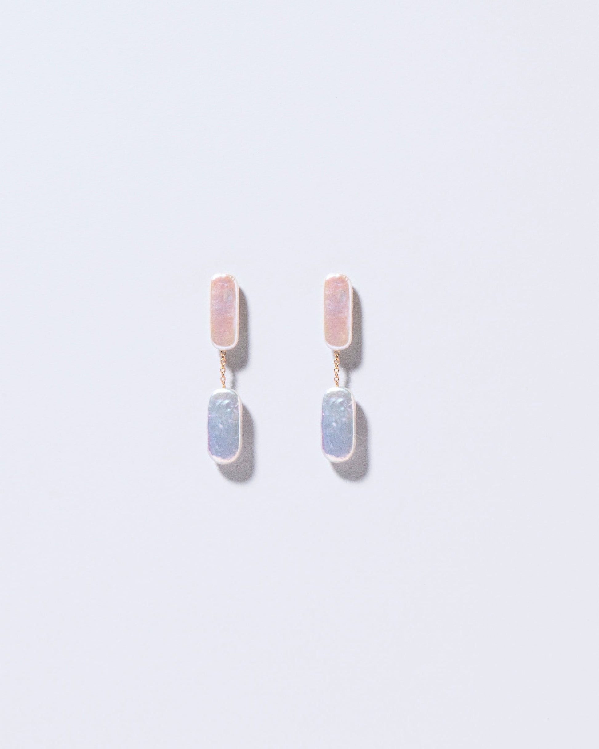  Neleus Earrings on light color background.