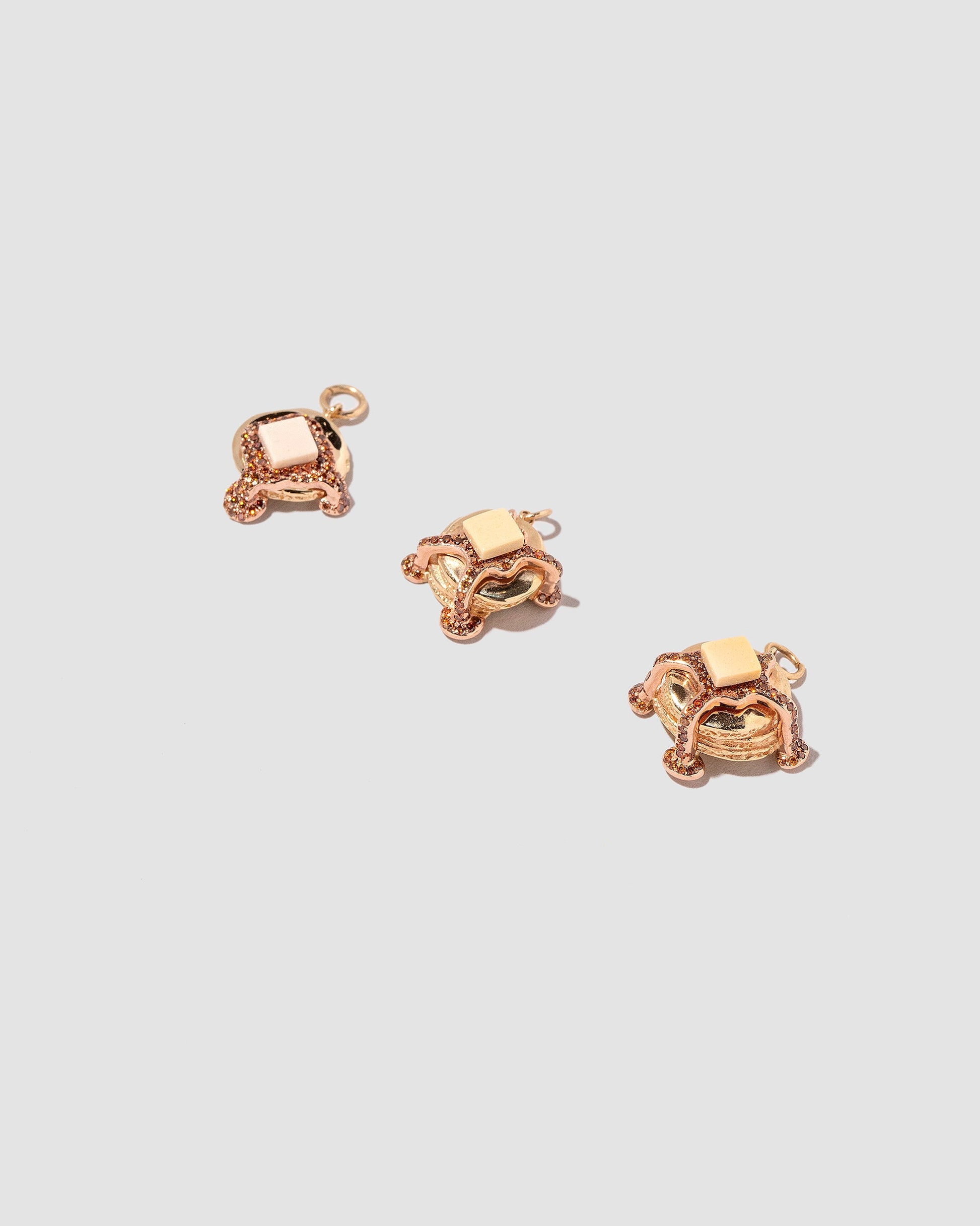 Group of Pancake Charms on light color background.