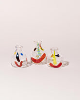 Group of FACEVESSEL Small Bud Vases on light color background.