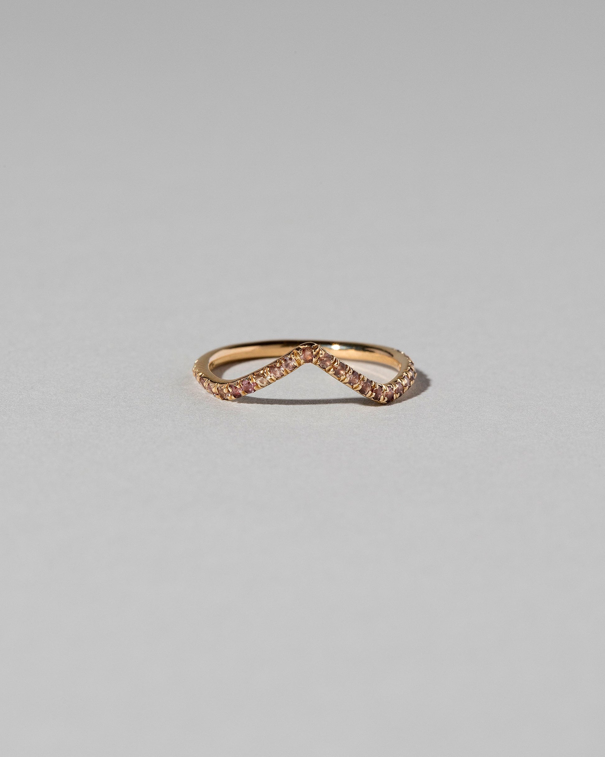 Gold Peach Sapphire Pavé High Peak Band on light color background.