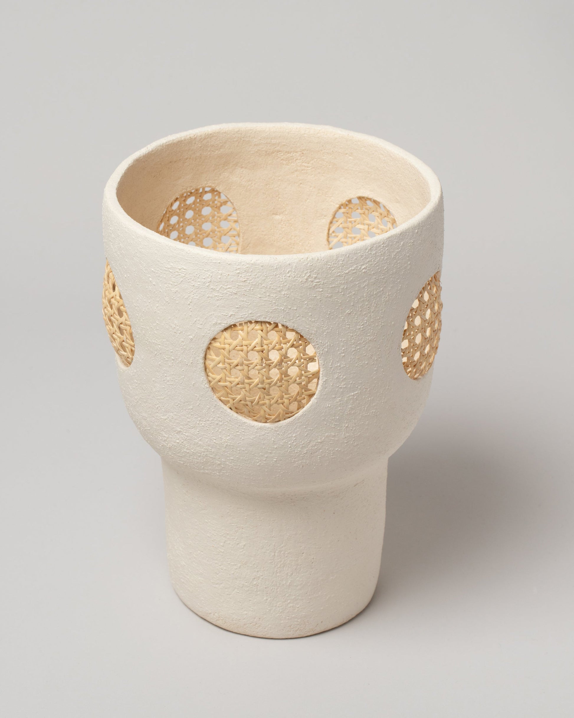 Details view of the Stephanie Phillips Cream Rattan Vessel on light color background.