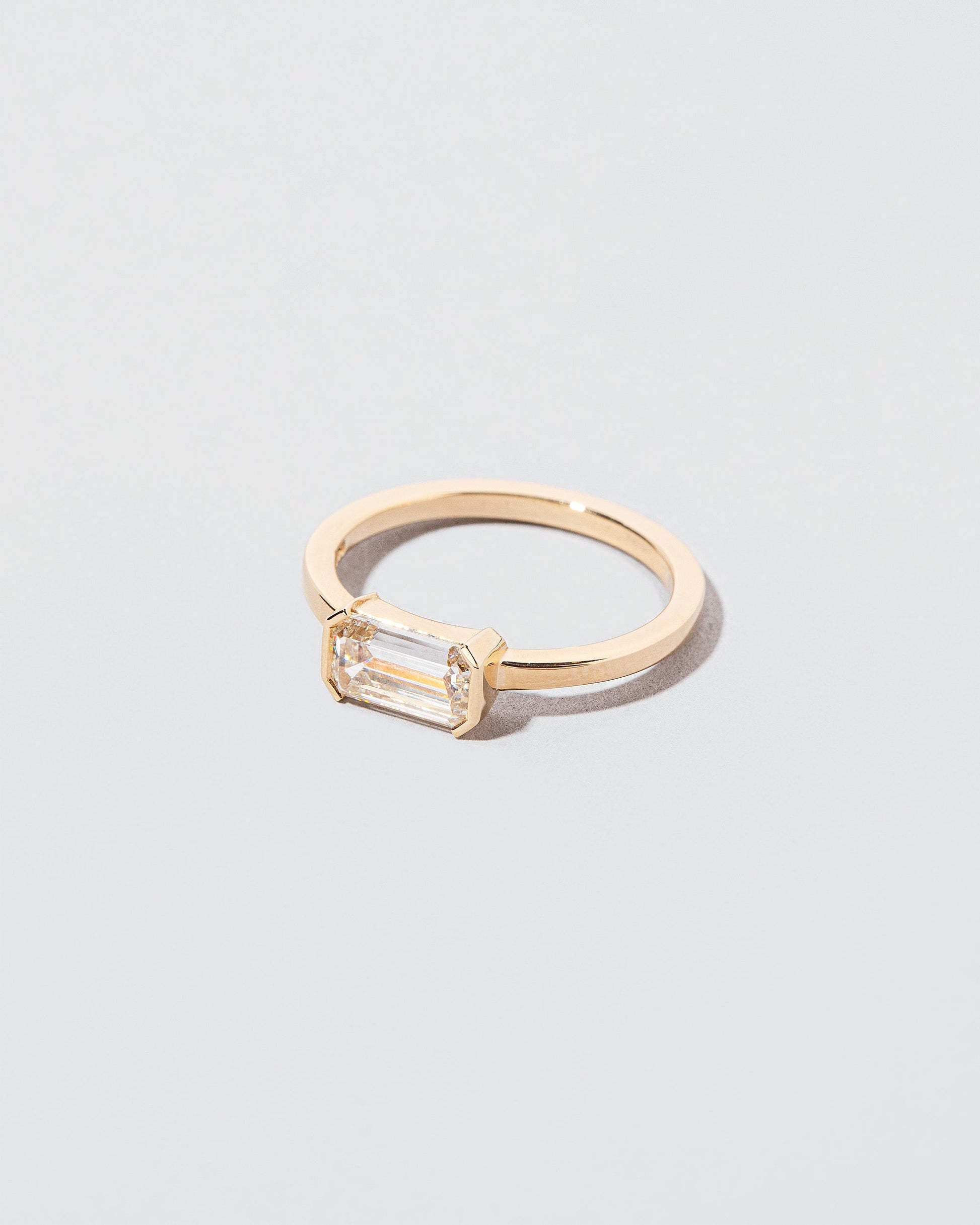 View from the side of the Tethys Diamond Ring on light color background.