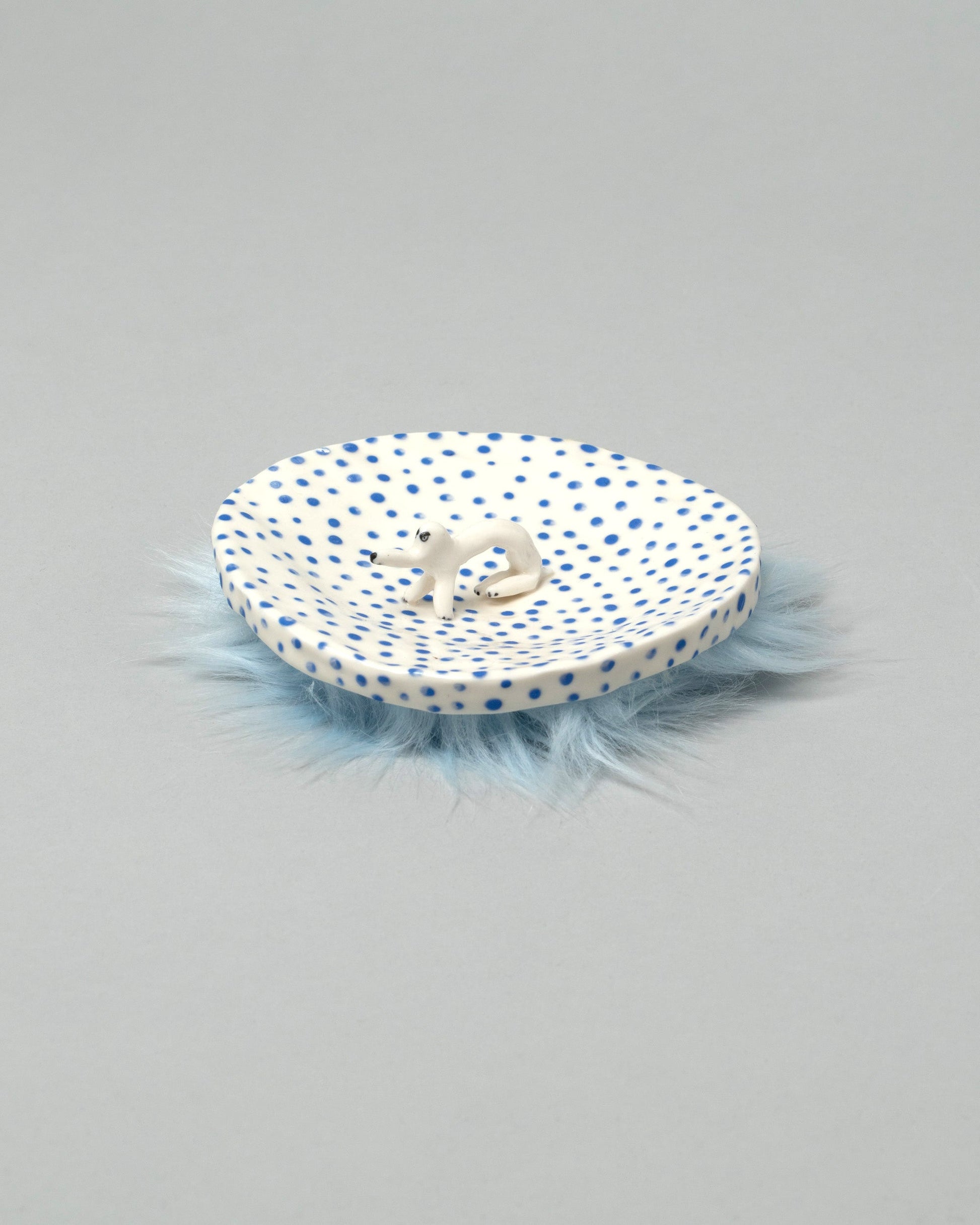 Eleonor Boström Furry Dog Plate on light color background.