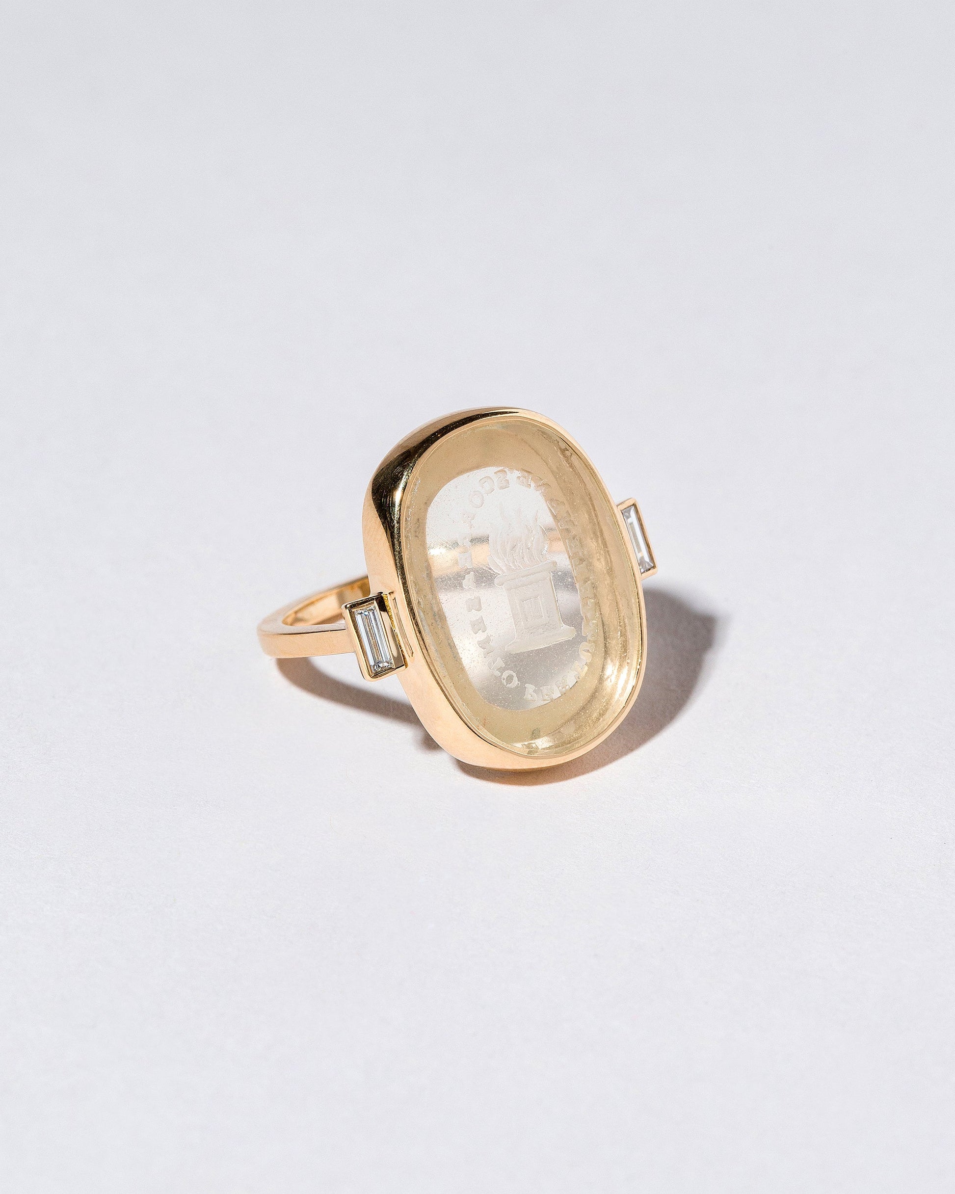 Closeup details of the Passion Intaglio Seal Ring on light color background.