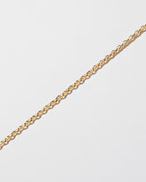 Closeup details of the Short Loop Chain Necklace on light color background.