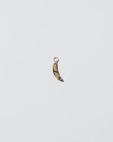 Bruised Banana Charm on light color background.