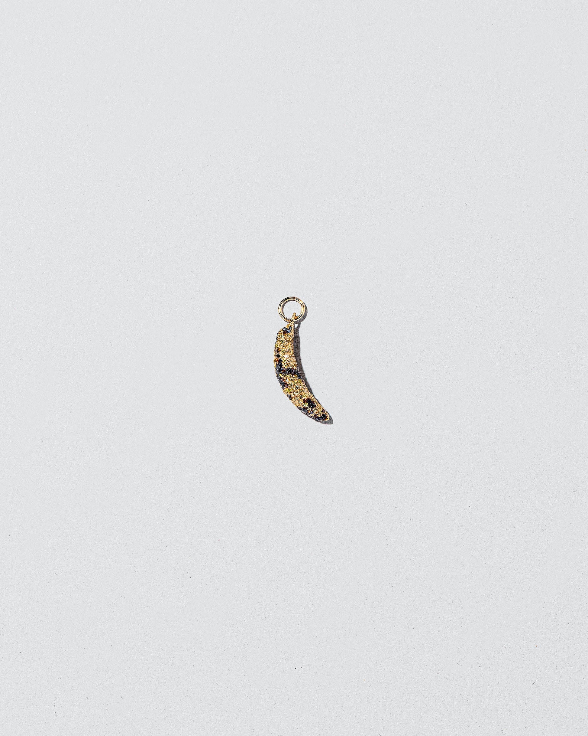 Bruised Banana Charm on light color background.