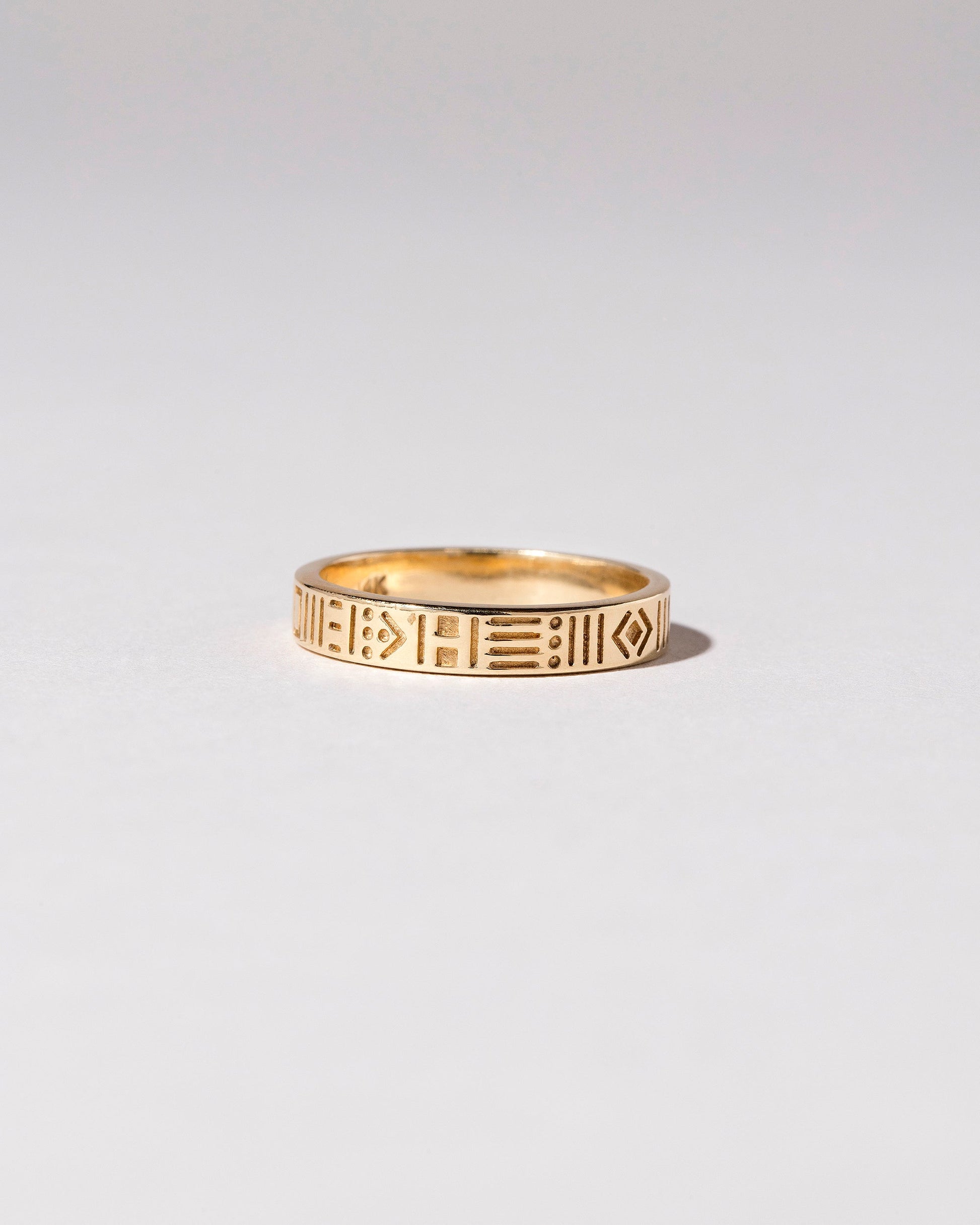 Gold Infinity Etched Band on light color background.