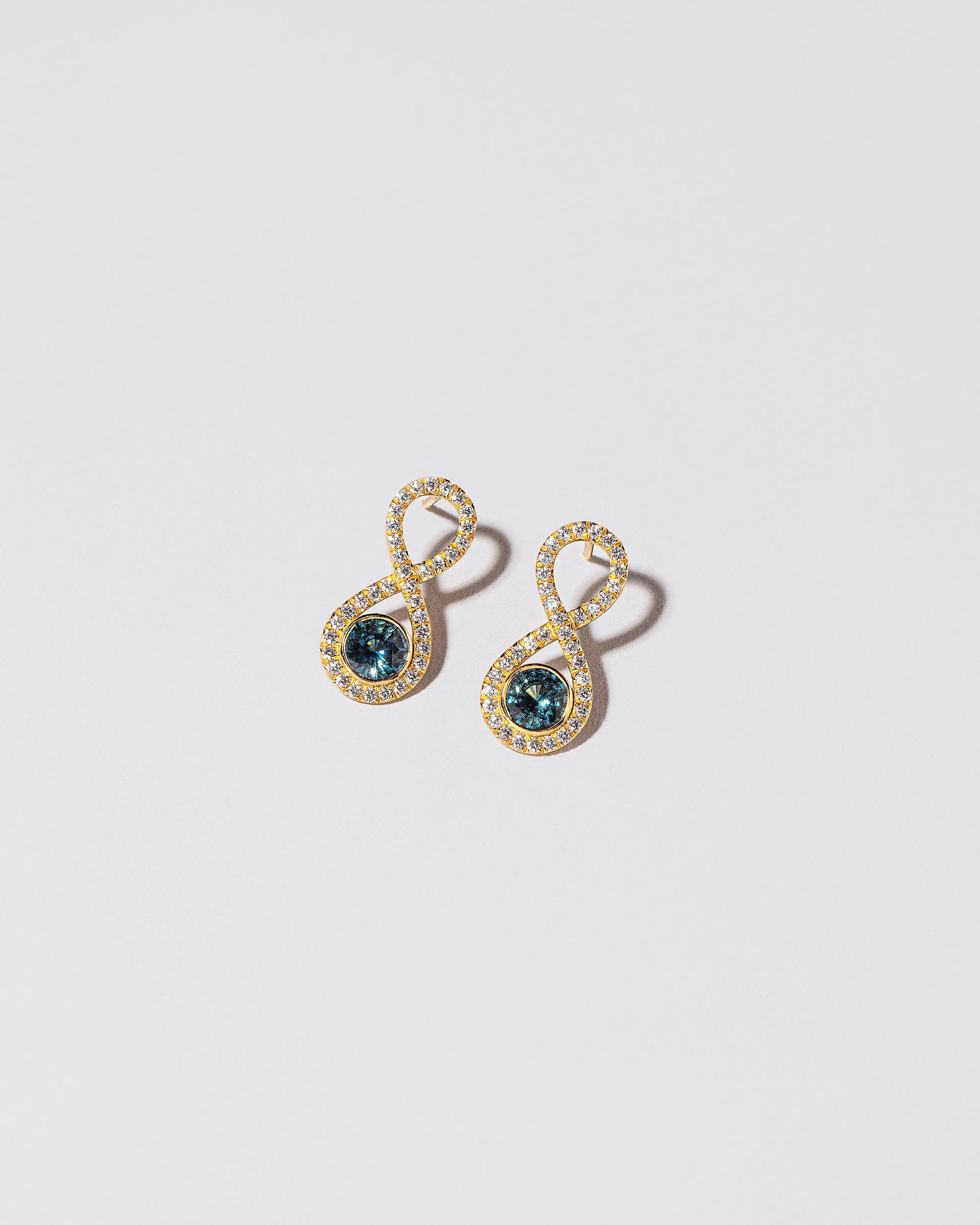  Ouroboros Earring on light color background.