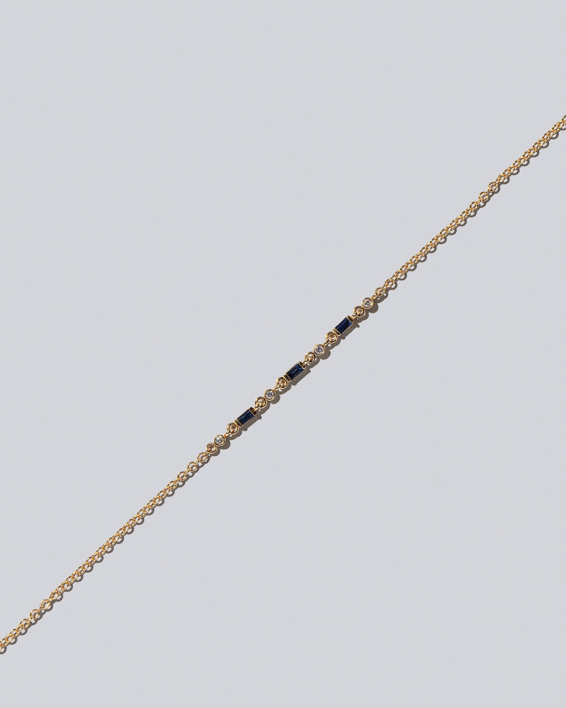 Closeup detail of the Blue Sapphire Consecutive Building Block Bracelet on light color background.