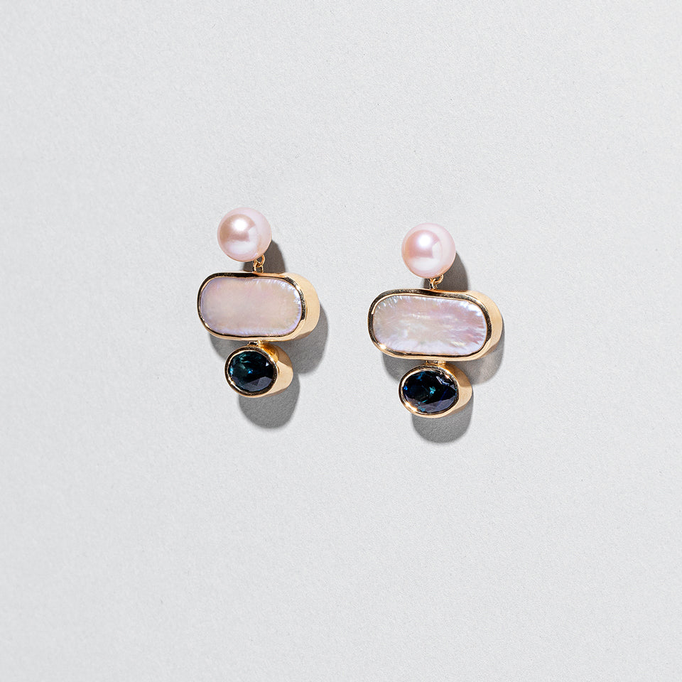 product_details:: Mantle Earrings on light color background.