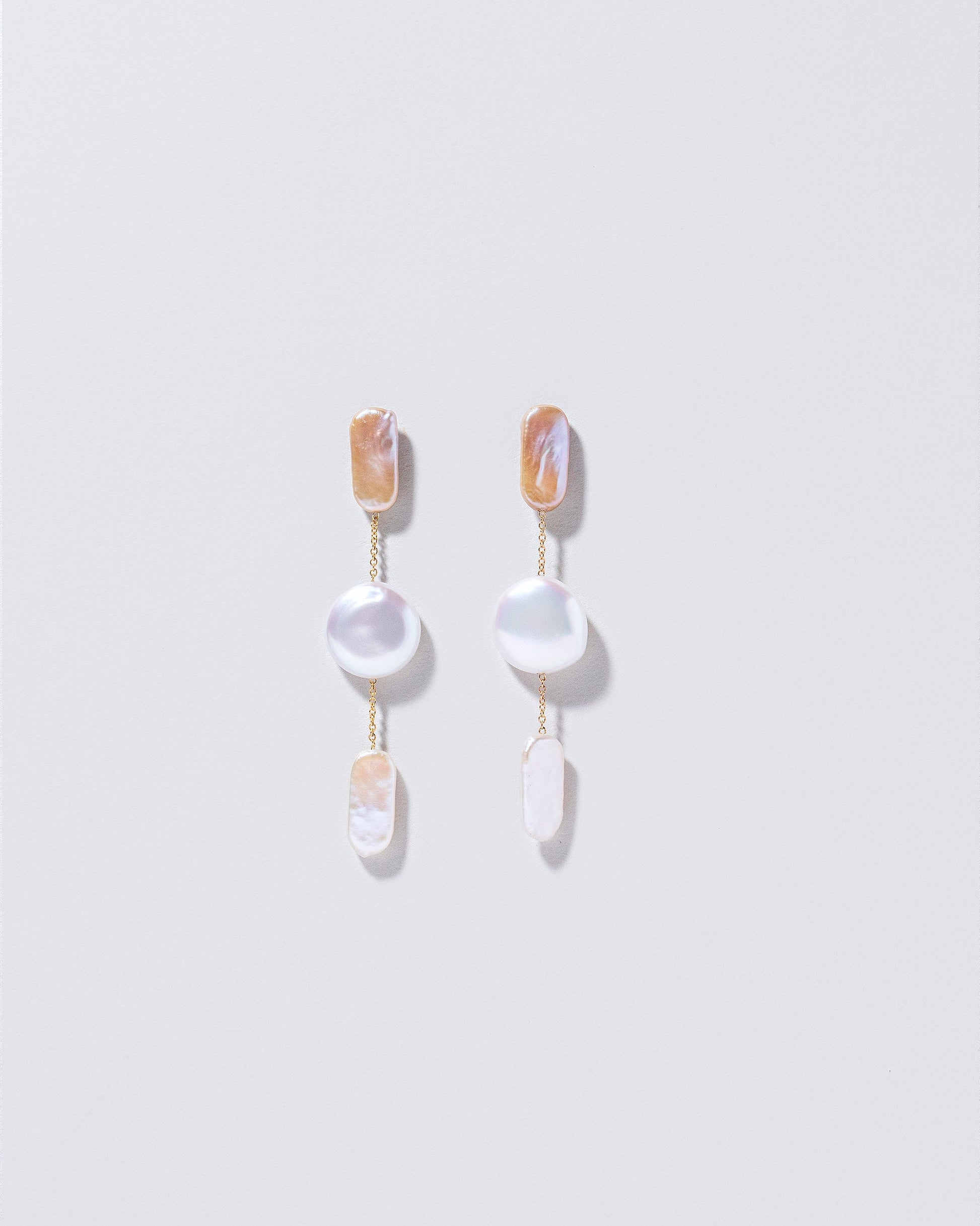  Theseus Earrings on light color background.