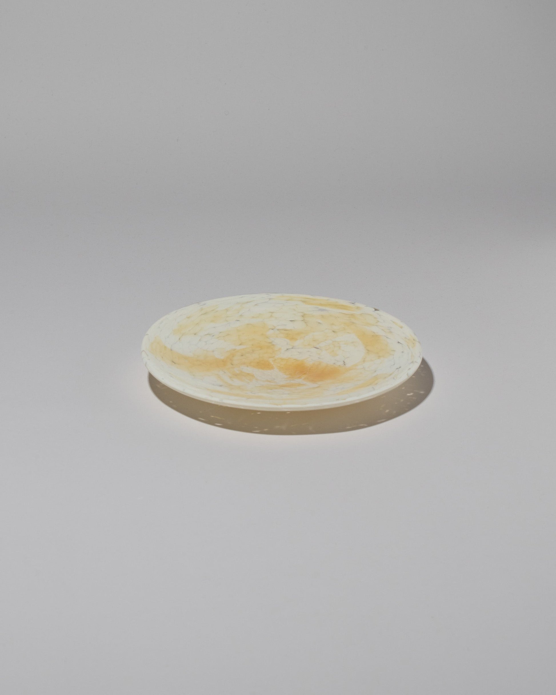 Stories of Italy Amber Nougat Dessert Plate on light color background.