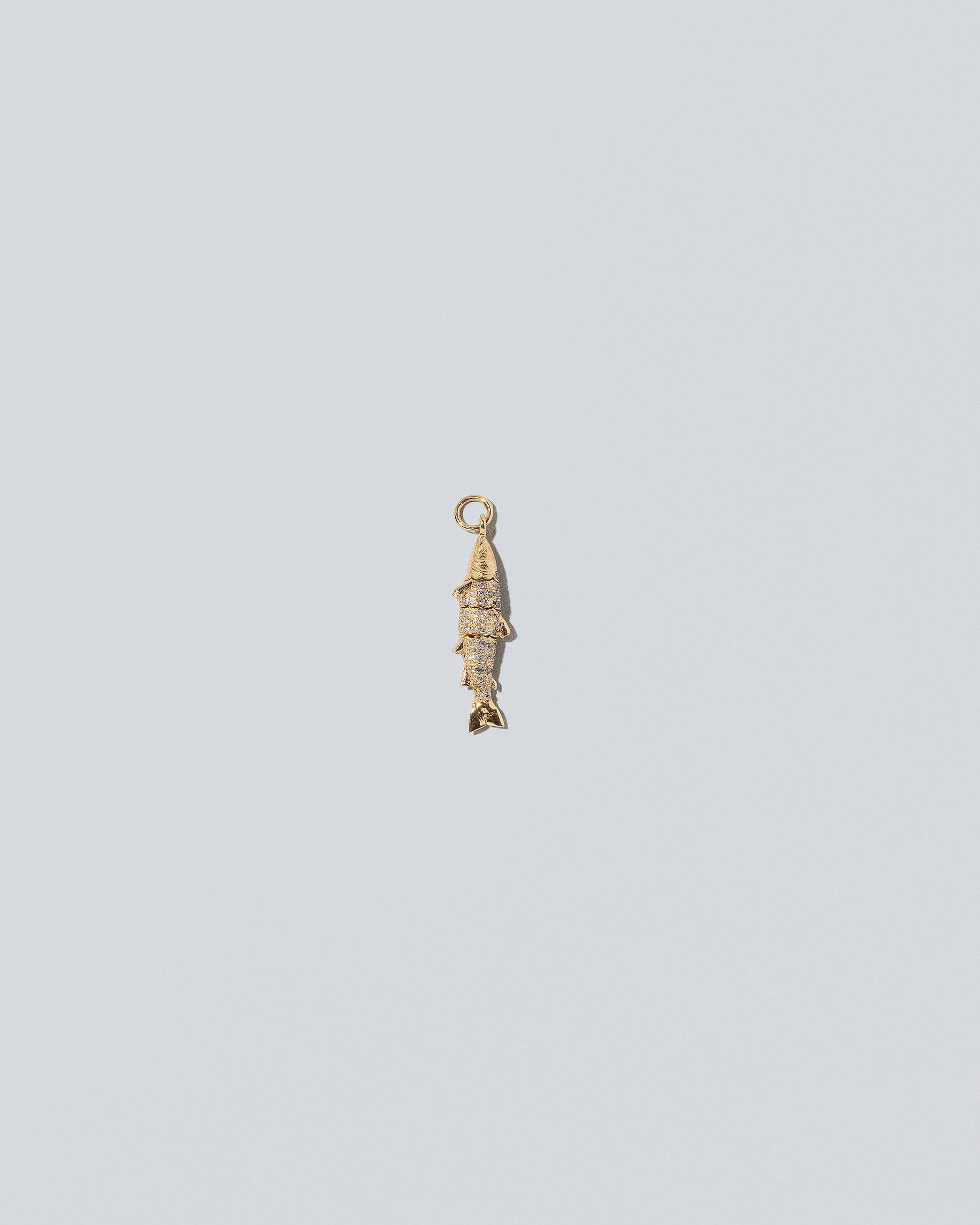 Pavé Fish Charm on light color background.