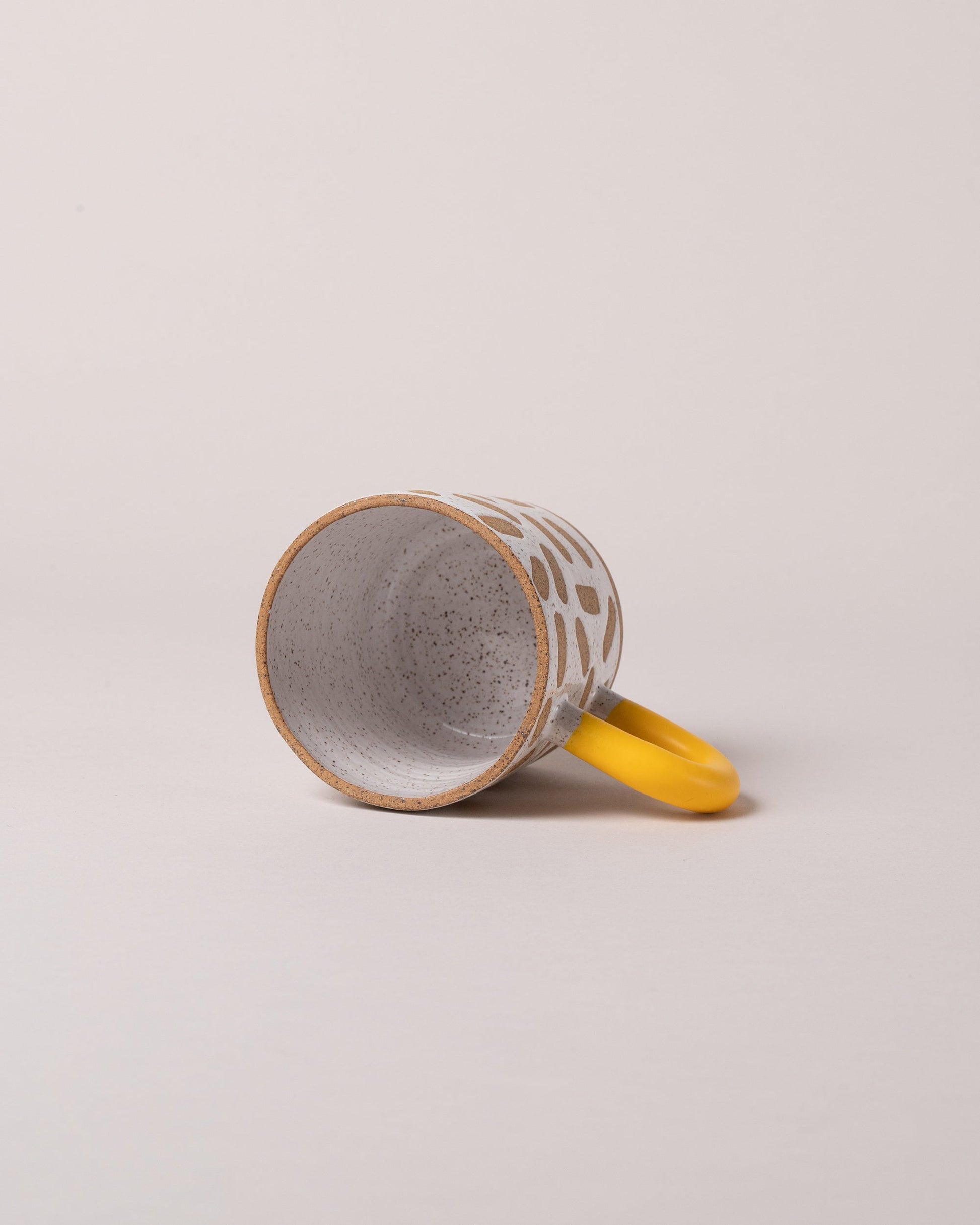  Detail view of Recreation Center Yellow Mark Mug on light color background.