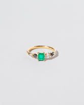 Emerald Seven Sisters Ring on light color background.