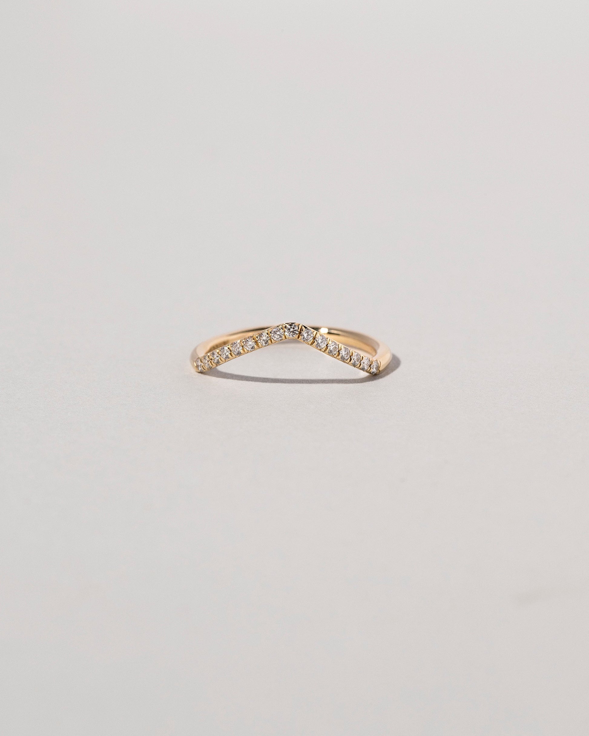 Gold Pavé White Diamond Low Peak Band on light color background.
