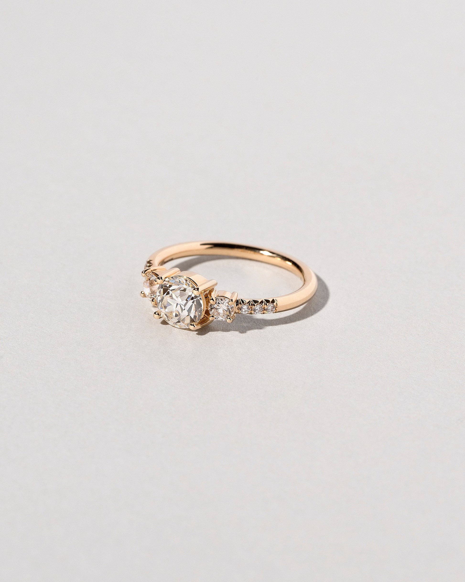 View from the side of past version of the White Diamond Orion Ring on light color background.