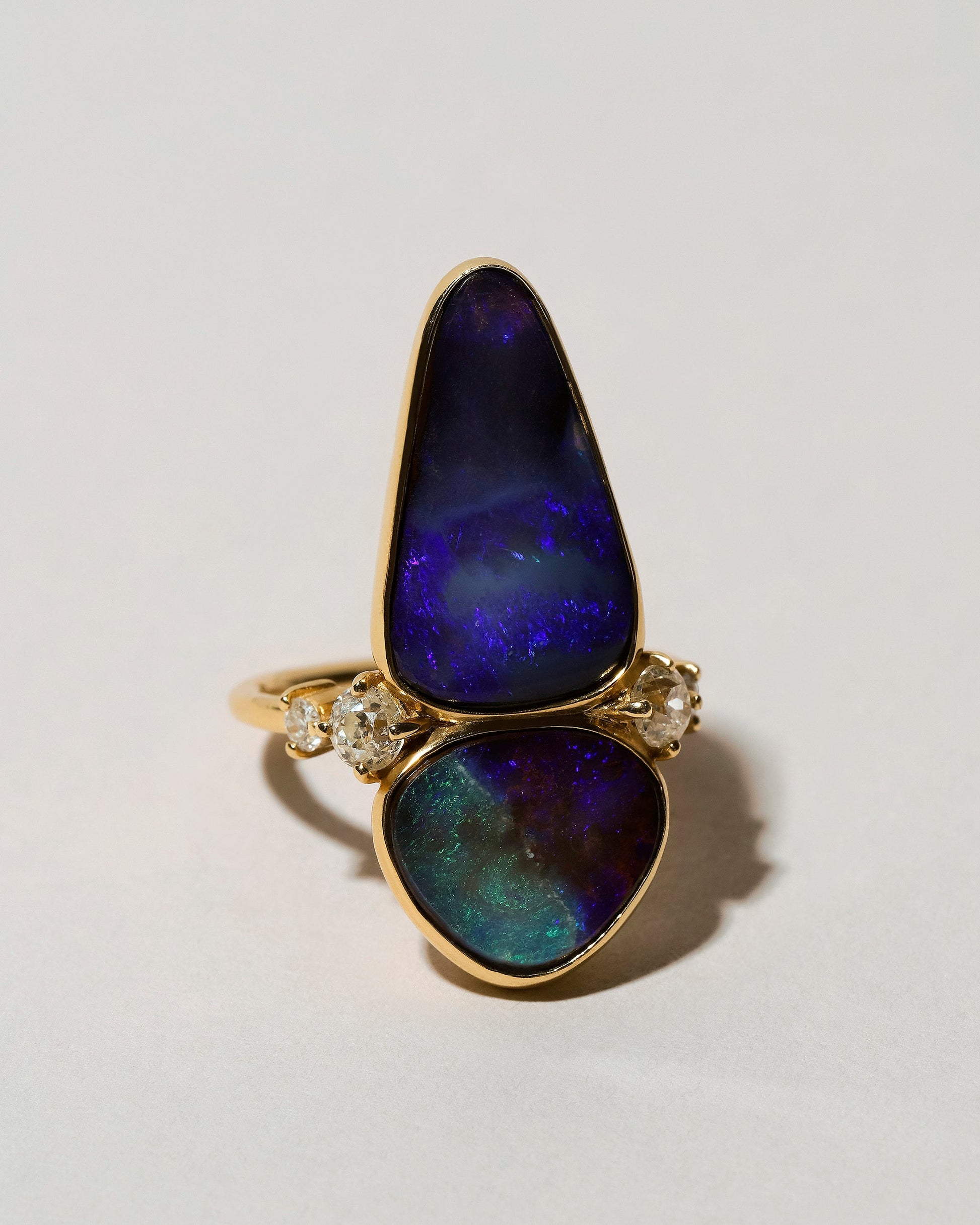 View from the side of the Australian Boulder Opal Ring on light color background.