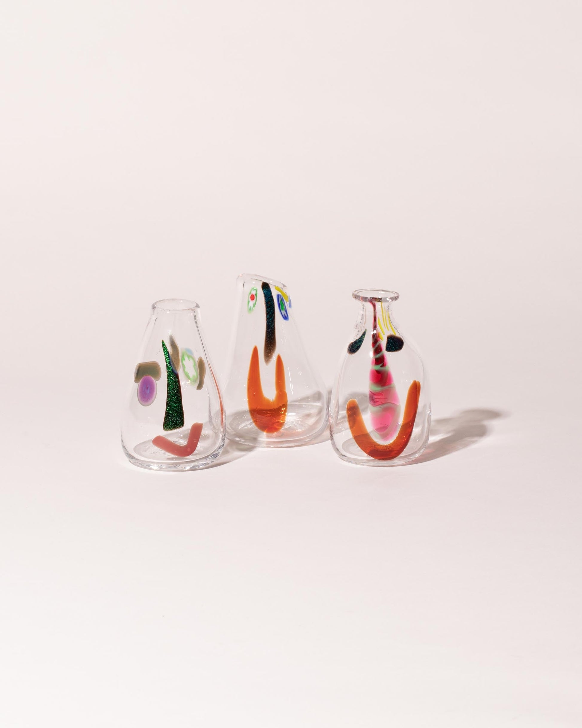 Group of FACEVESSEL Large Bud Vases on light color background.