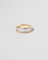 Gold Arcade Ring on light color background.
