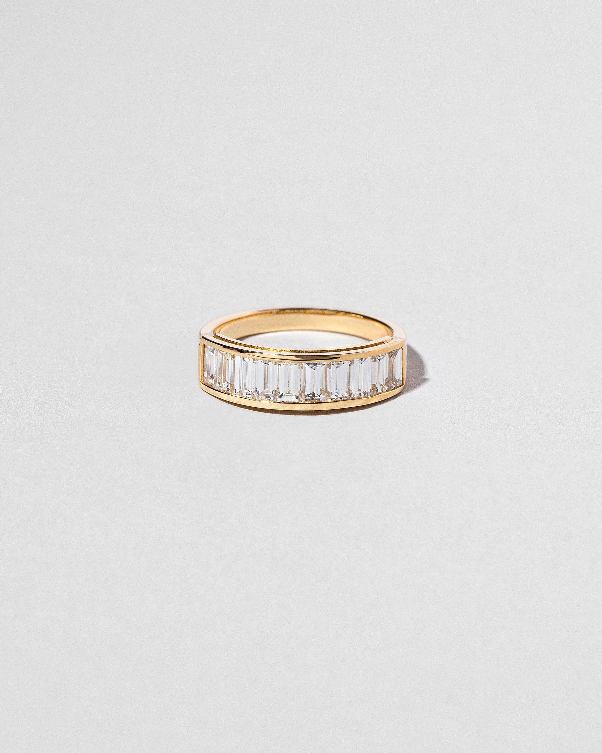 Gold Arcade Ring on light color background.