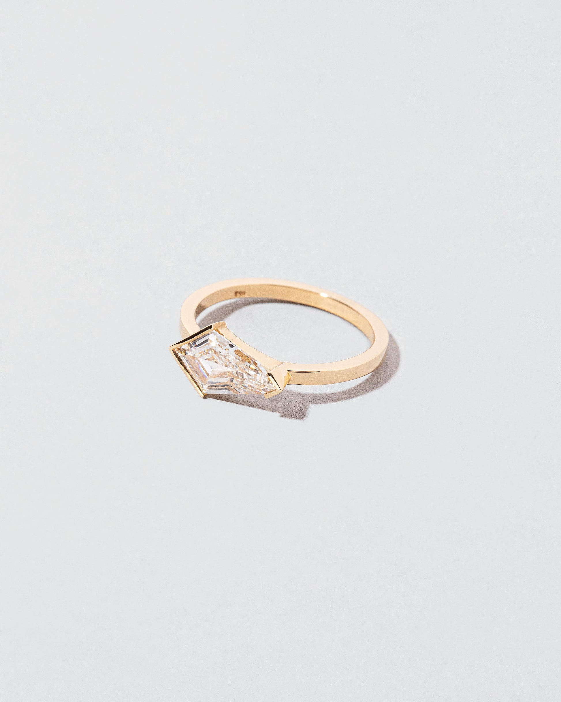 View from the side of the Dione Ring on light color background.