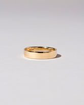 Closeup detail of the Gold 5mm Square Wire Band on light color background.