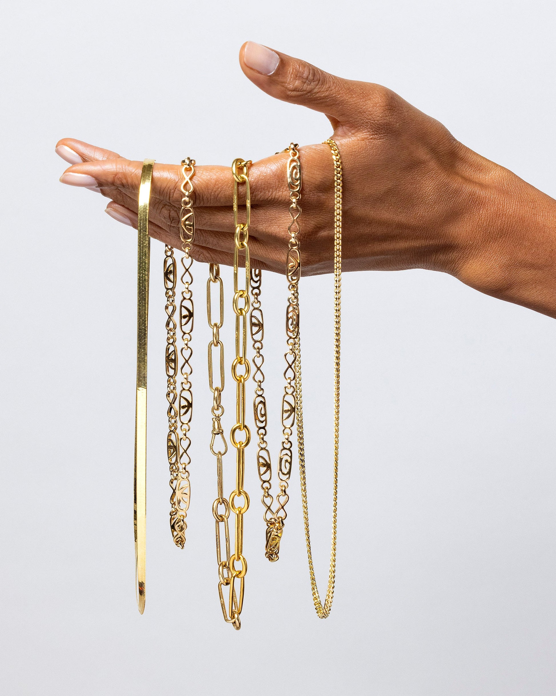 2.4mm Curb Chain Necklace, Infinite Spiral Necklaces, Solid Link Necklace and 4.6mm Liquid Chain on model.