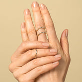 product_details::Gold Five Stone Low Peak Bands on model.