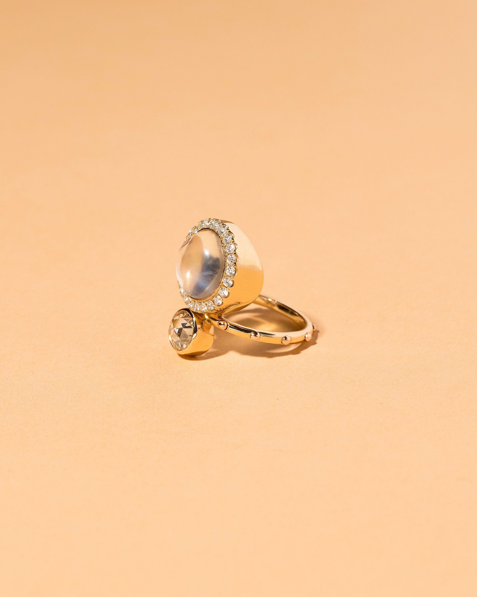  Moonstone & Diamond Cluster Ring on light color background.