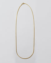 1mm Ritual Chain Necklace on light color background.