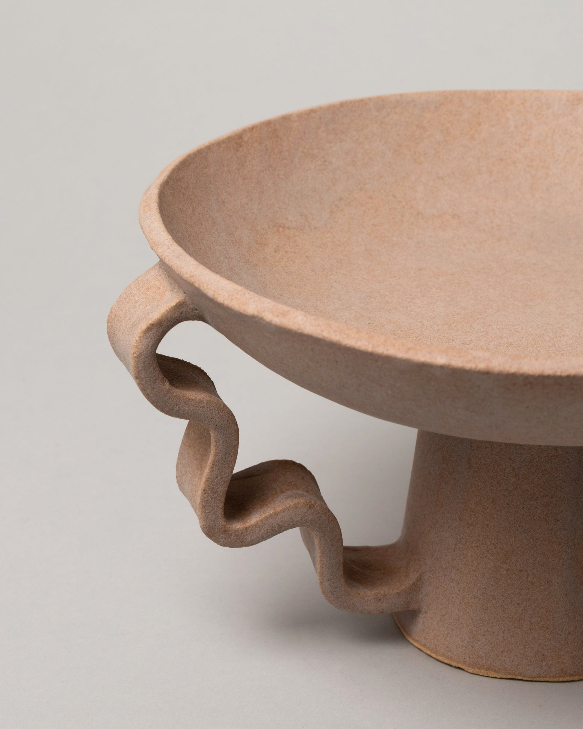 Detail view of Morgan Peck Mauve Stretch Bowl on light color background.