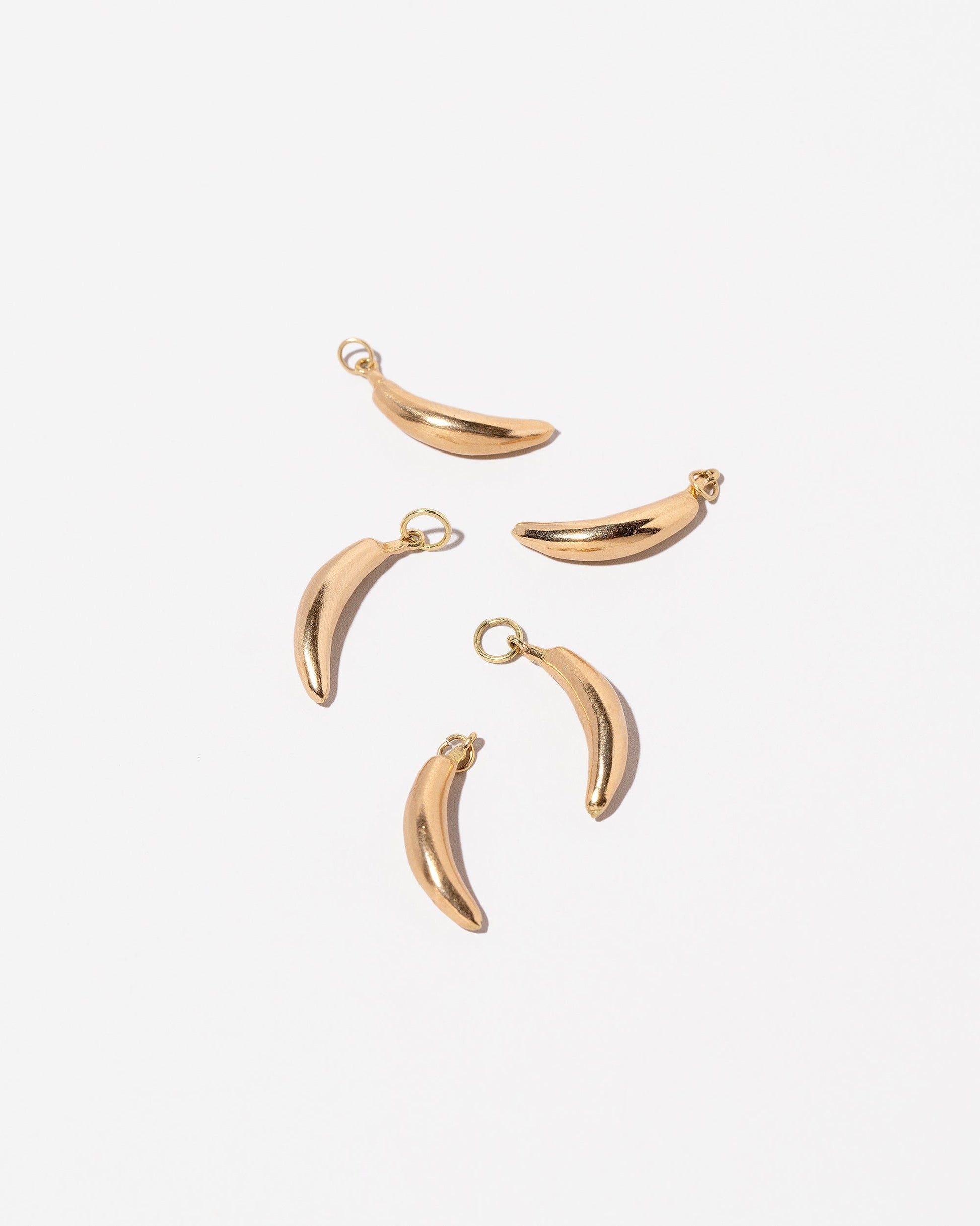 Group of Banana Charms - Plain on light color background.