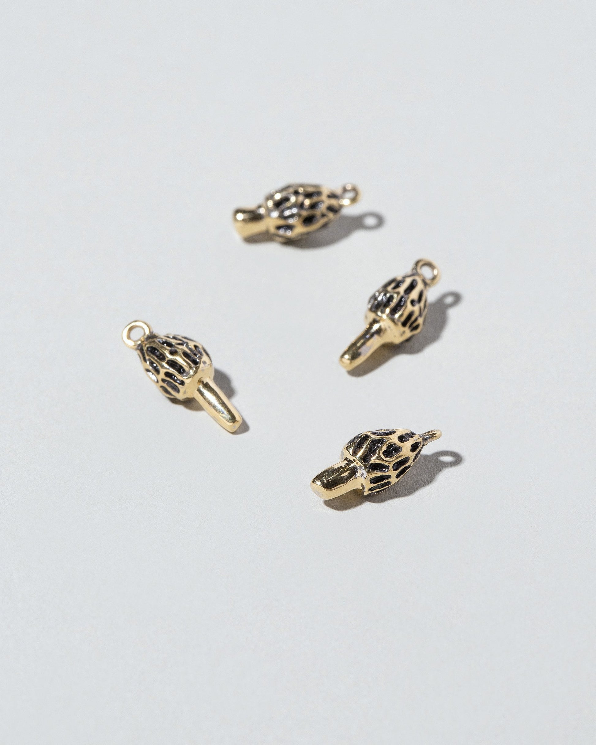  Morel Mushroom Charm on light color background.