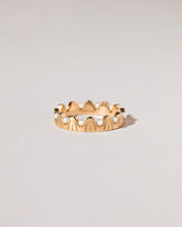 Gold Pearls of Wisdom Band on light color background.