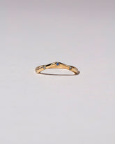 Gold Blue Sapphire Five Stone Low Peak Band on light color background.