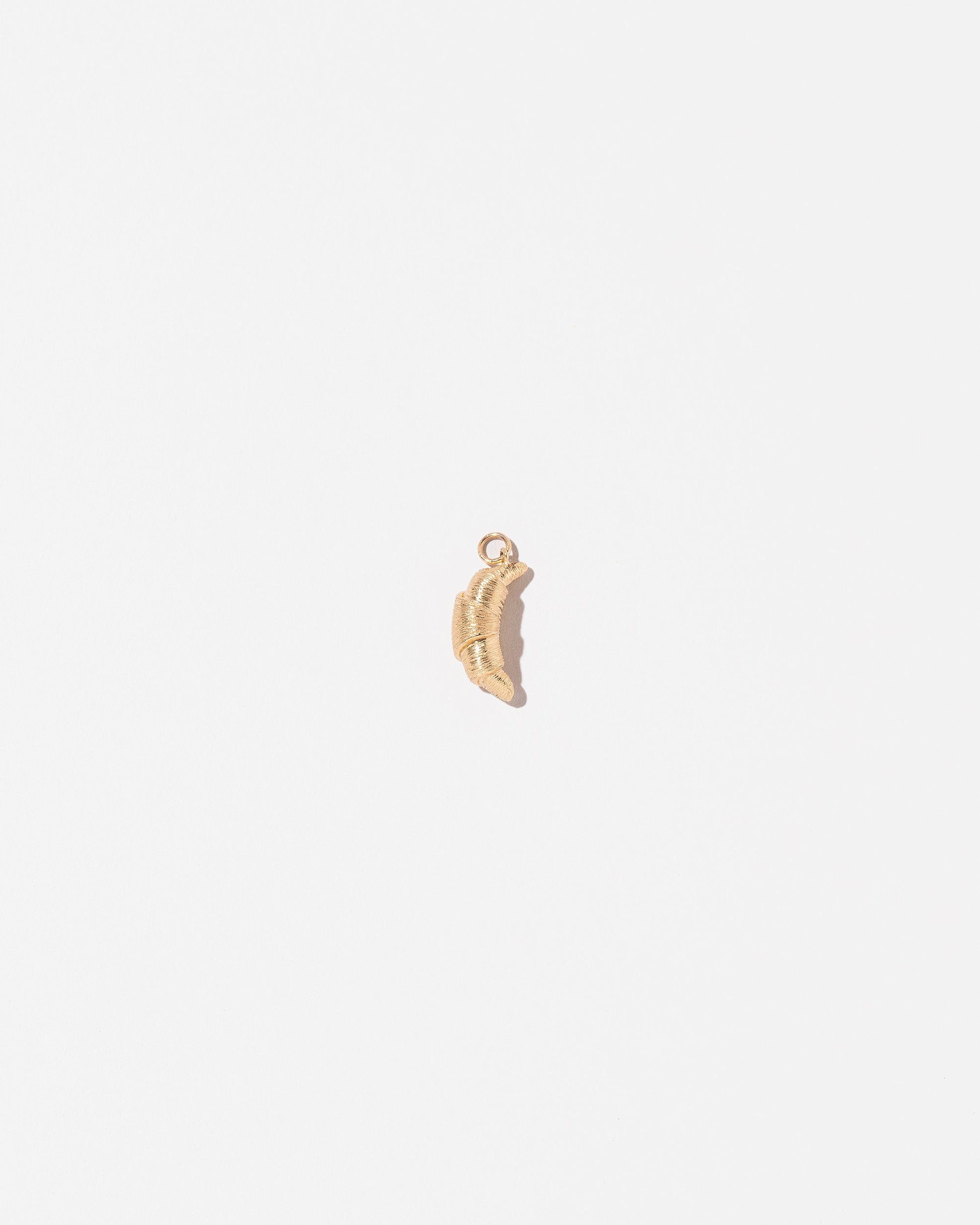  Croissant Charm on light color background.