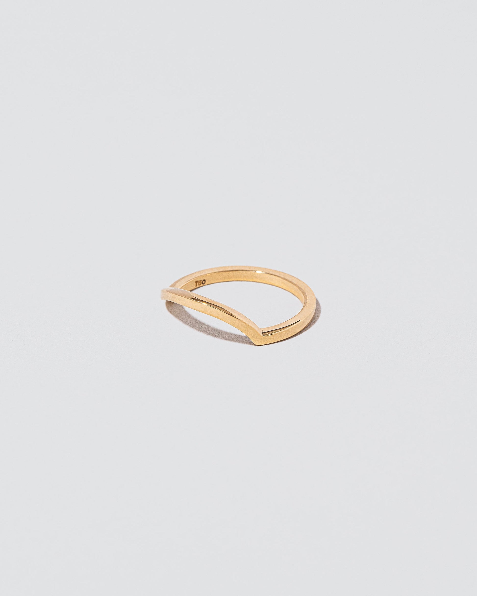 View from the side of the Gold Solid Square Wire Right Slump Band on light color background.