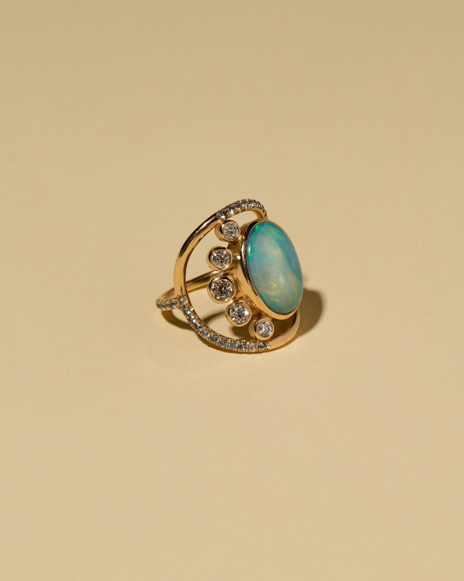 Australian Opal, Diamond & Sapphire Ring on light color background.