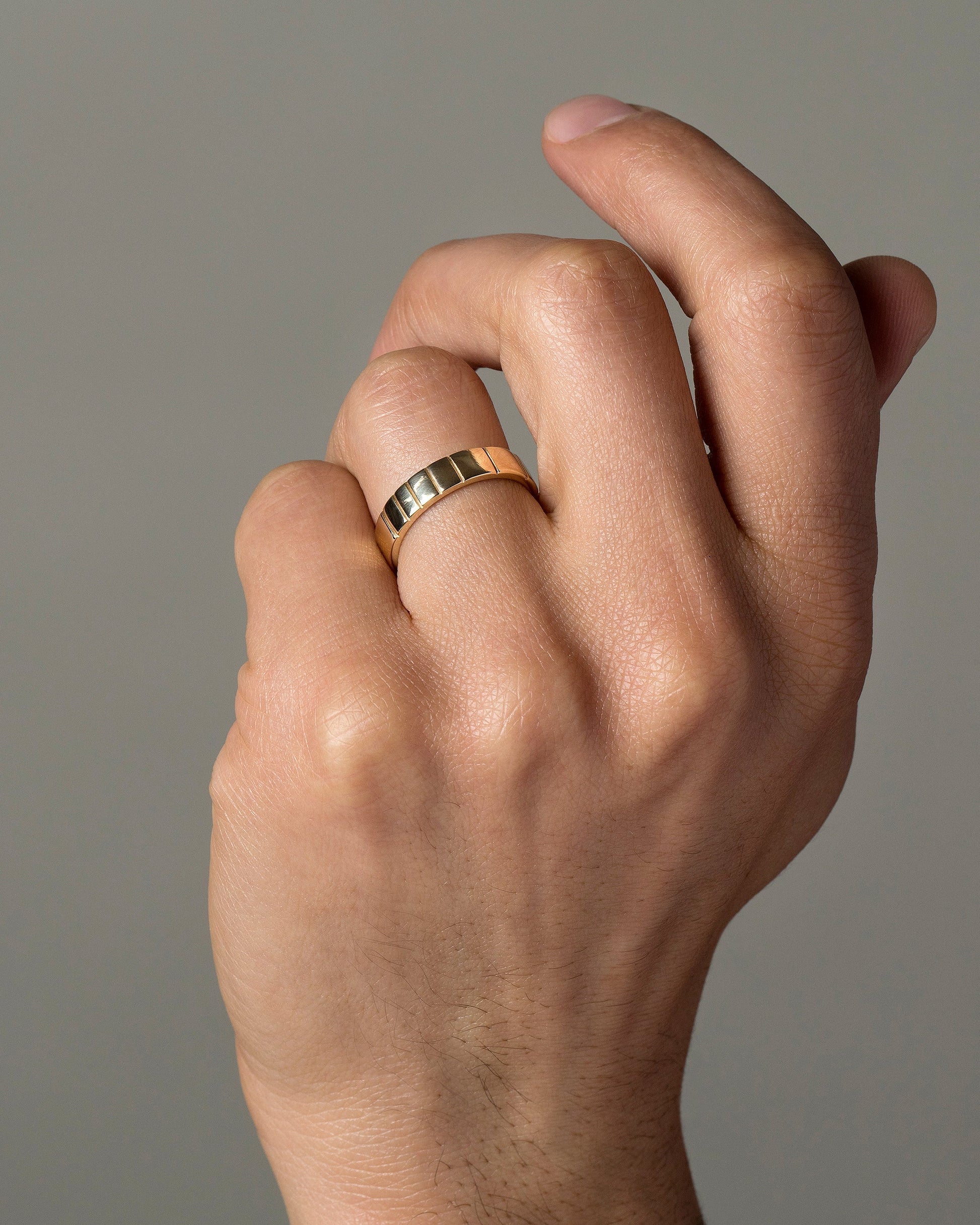 Gold 5mm Etched Lines Band on male model.